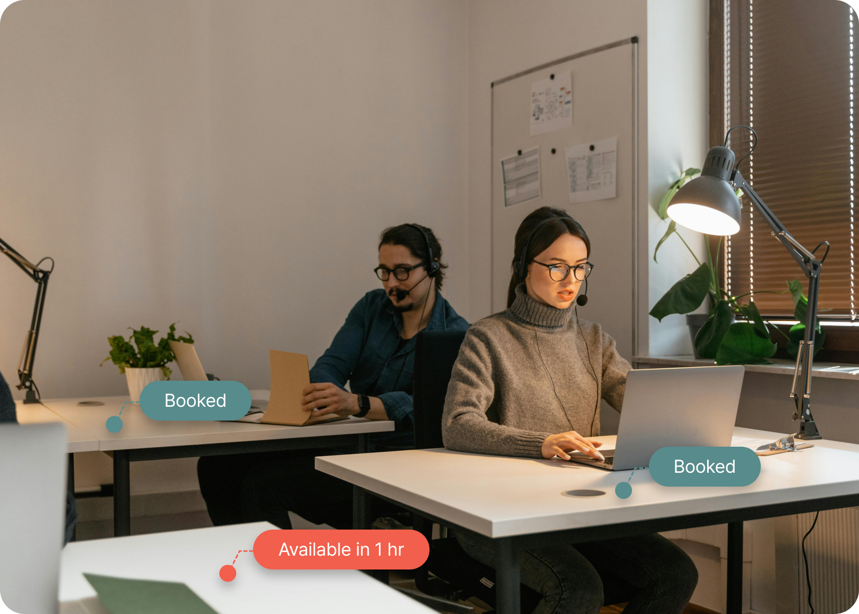 Two employees working at desks in a modern office