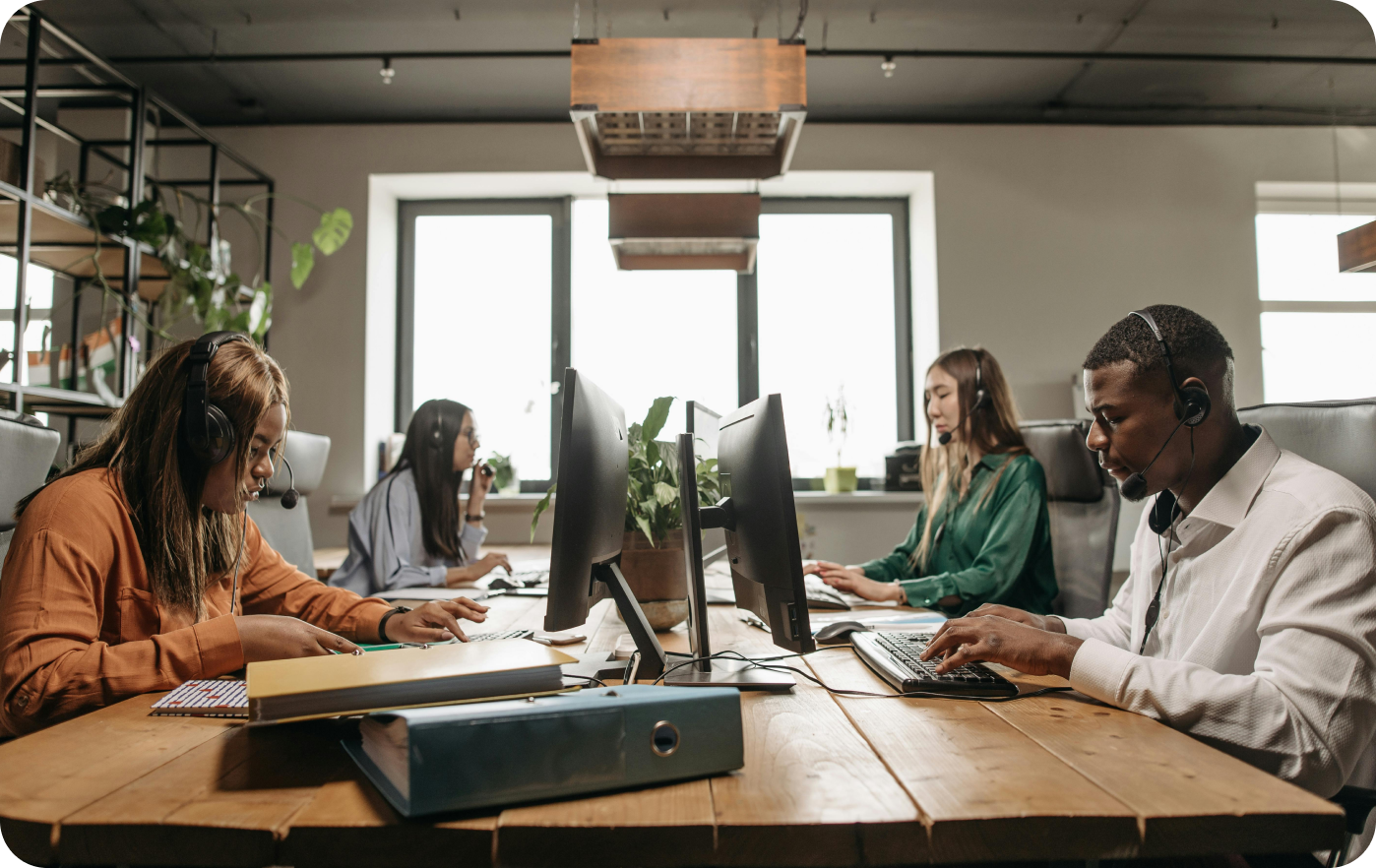 Team of professionals working together at desks in a modern hybrid office
